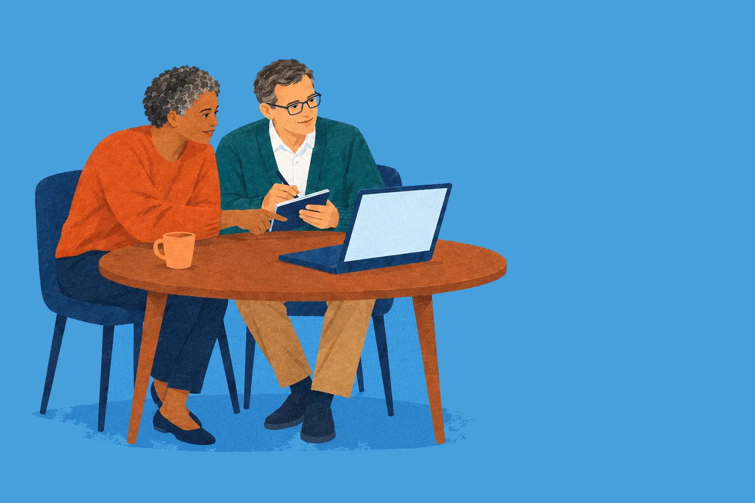 Two school staff members look at a laptop together at a table, one taking notes.